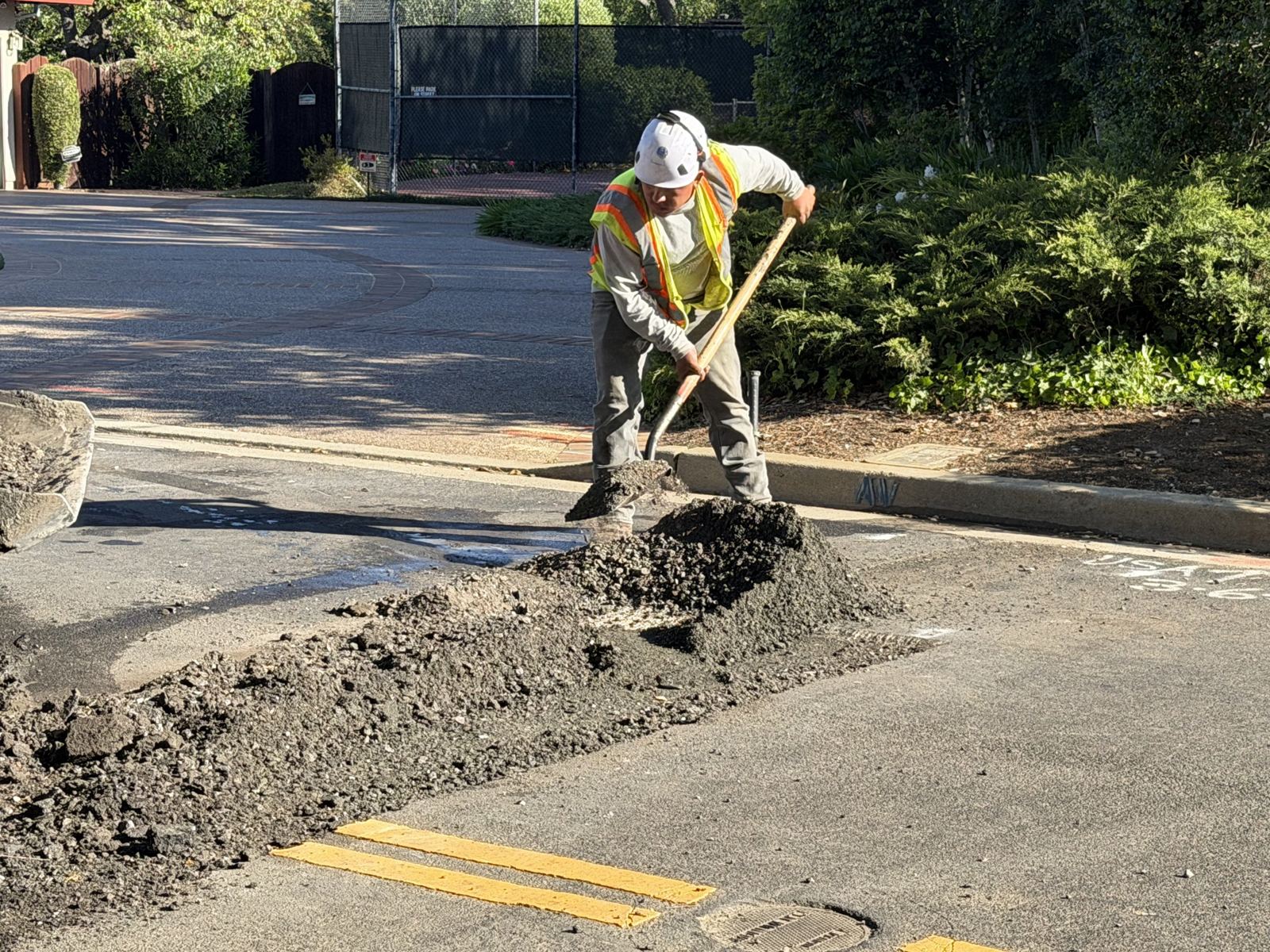 Placing hot-mix asphalt in a street patch