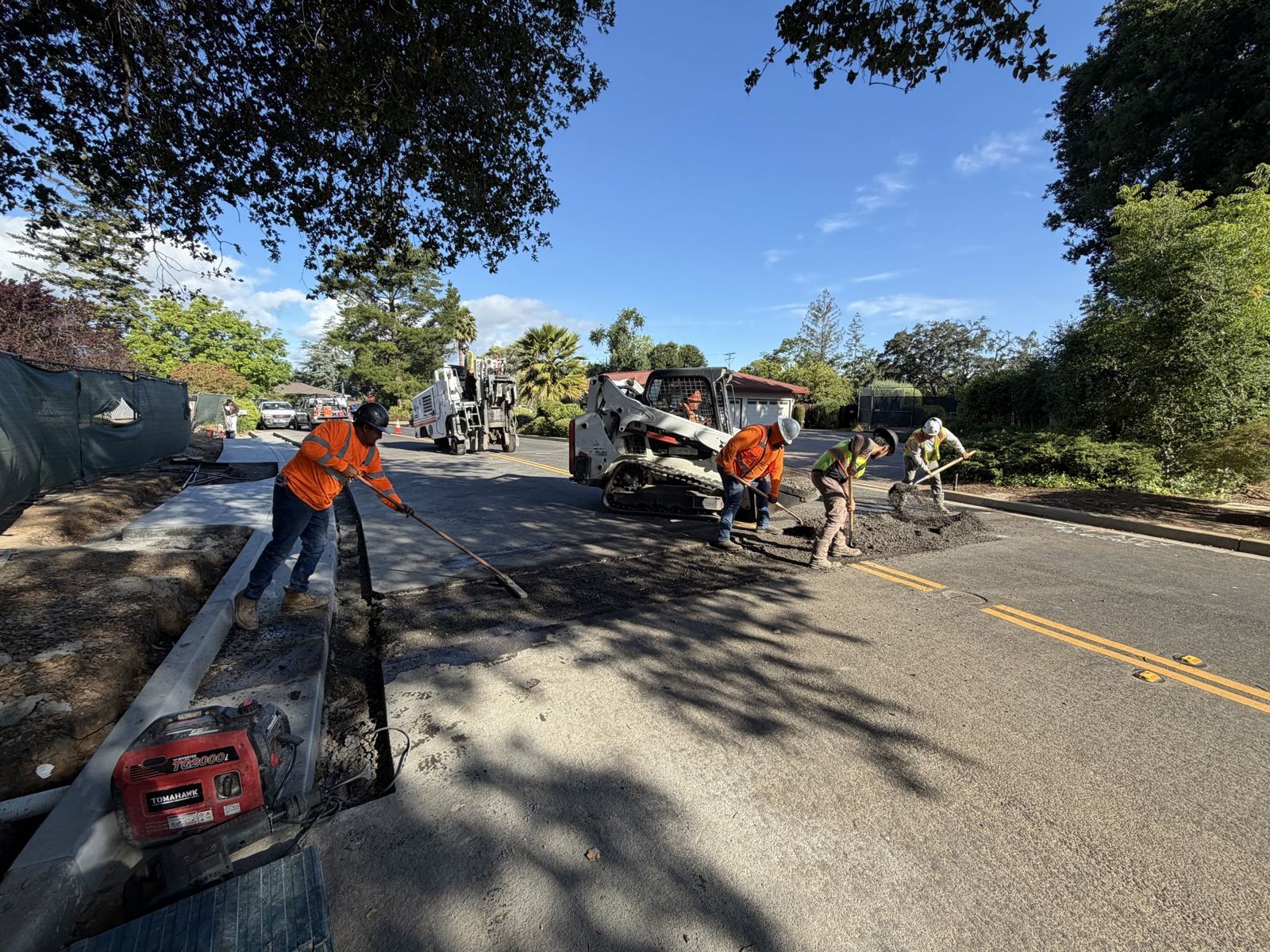Raking hot mix with skid steer support